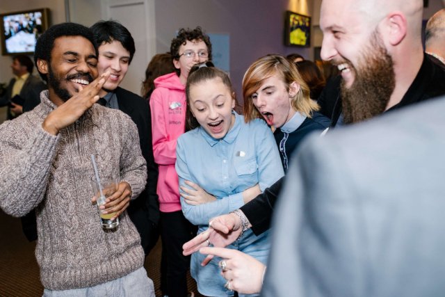 Group of teens huddled laughing