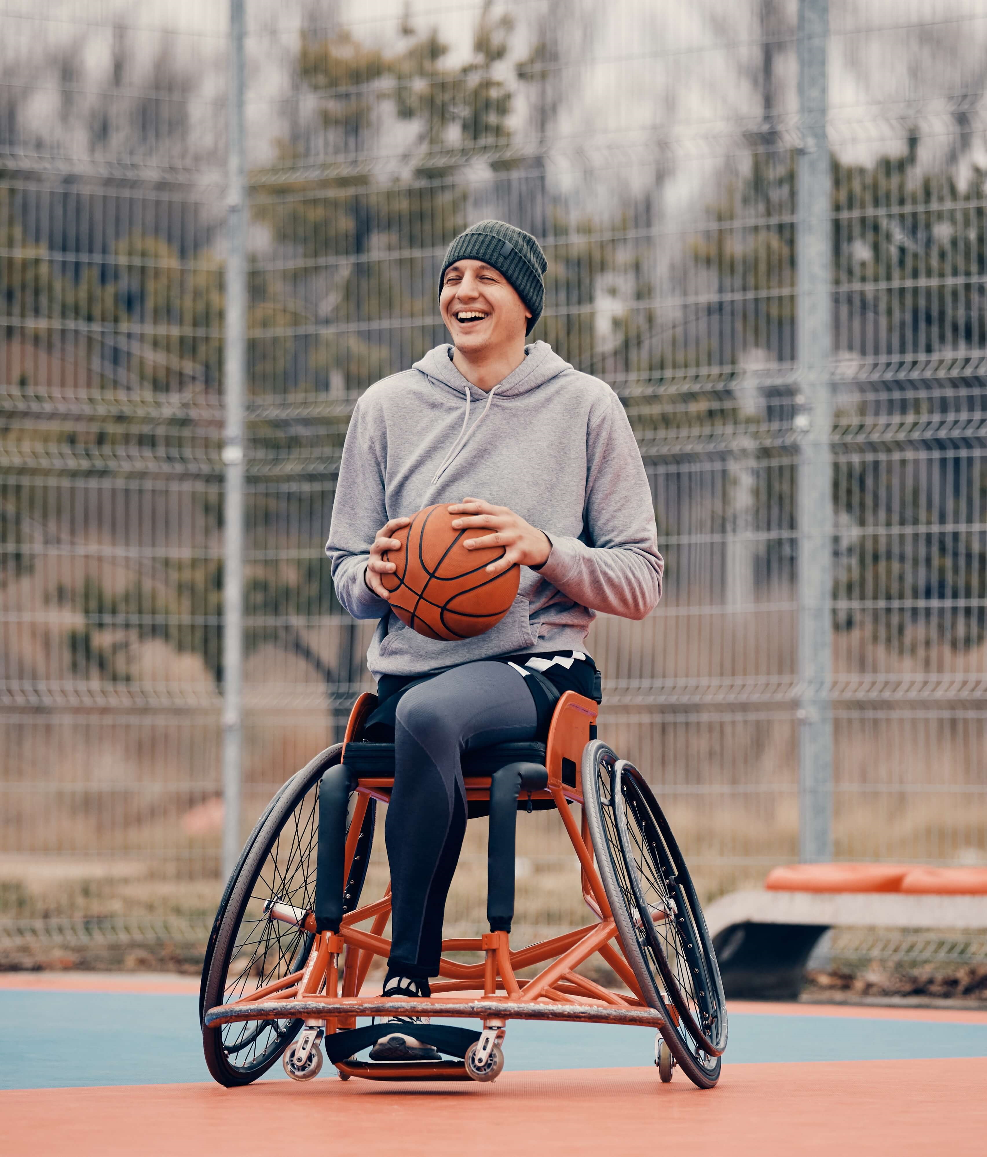 Wheelchair user holding a basketball
