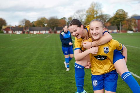 Girls celebrate playing football