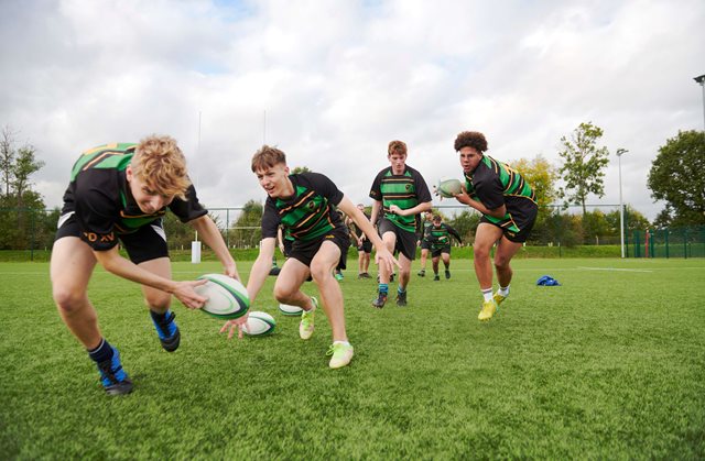 Group of teenagers playing rugby