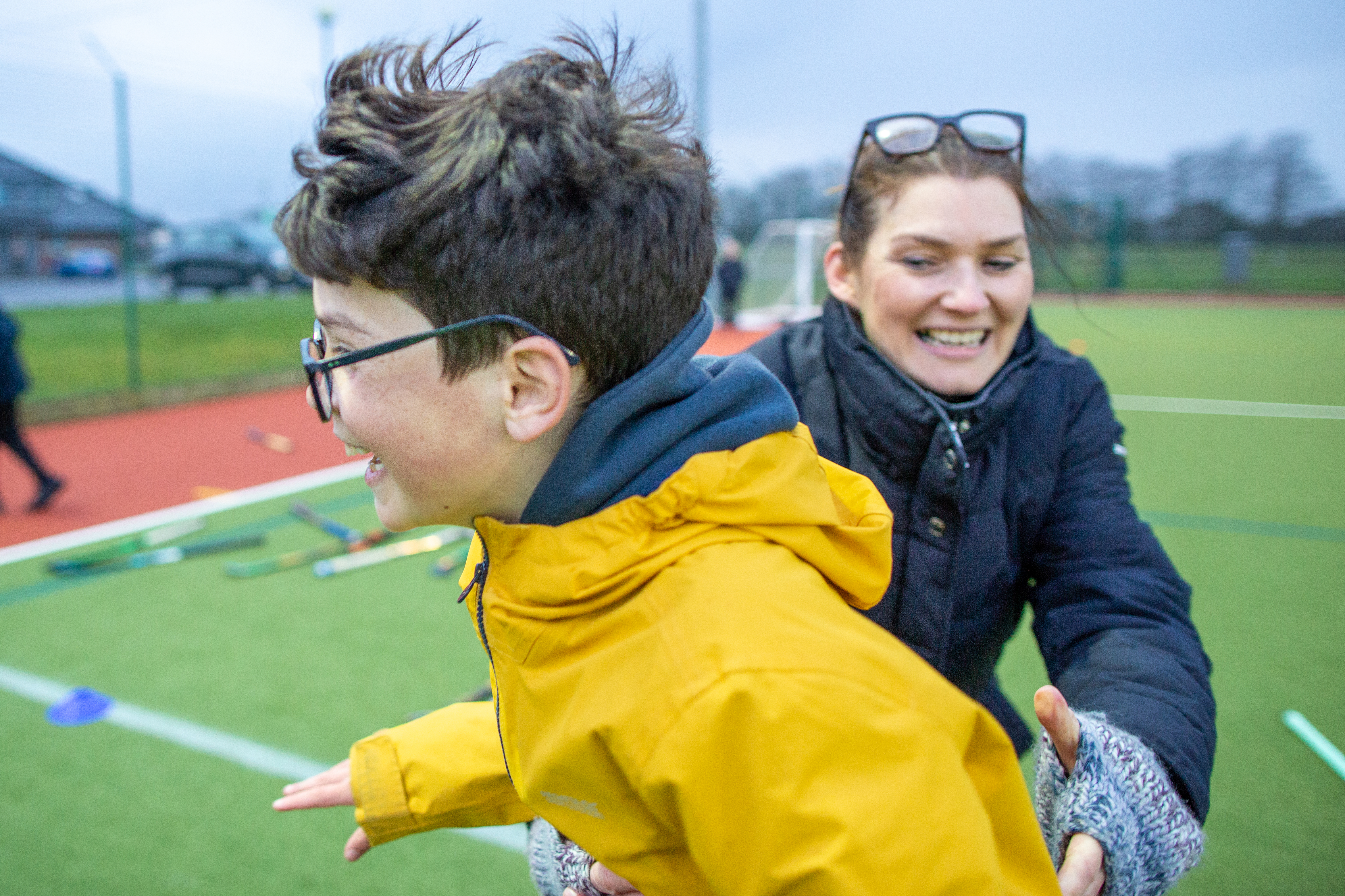 coaching children with mixed abilities - a coach and child playing hockey games
