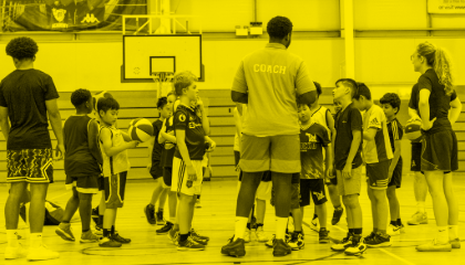 Group of children huddled around the coaches
