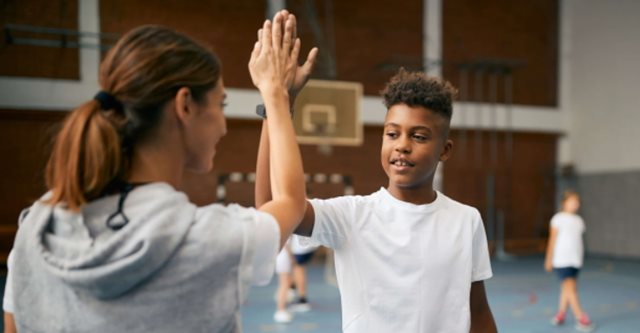 Coach high fiving teenager