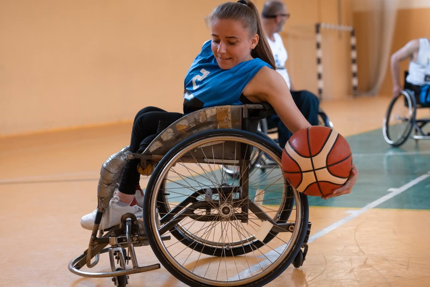 Wheelchair user playing basketball