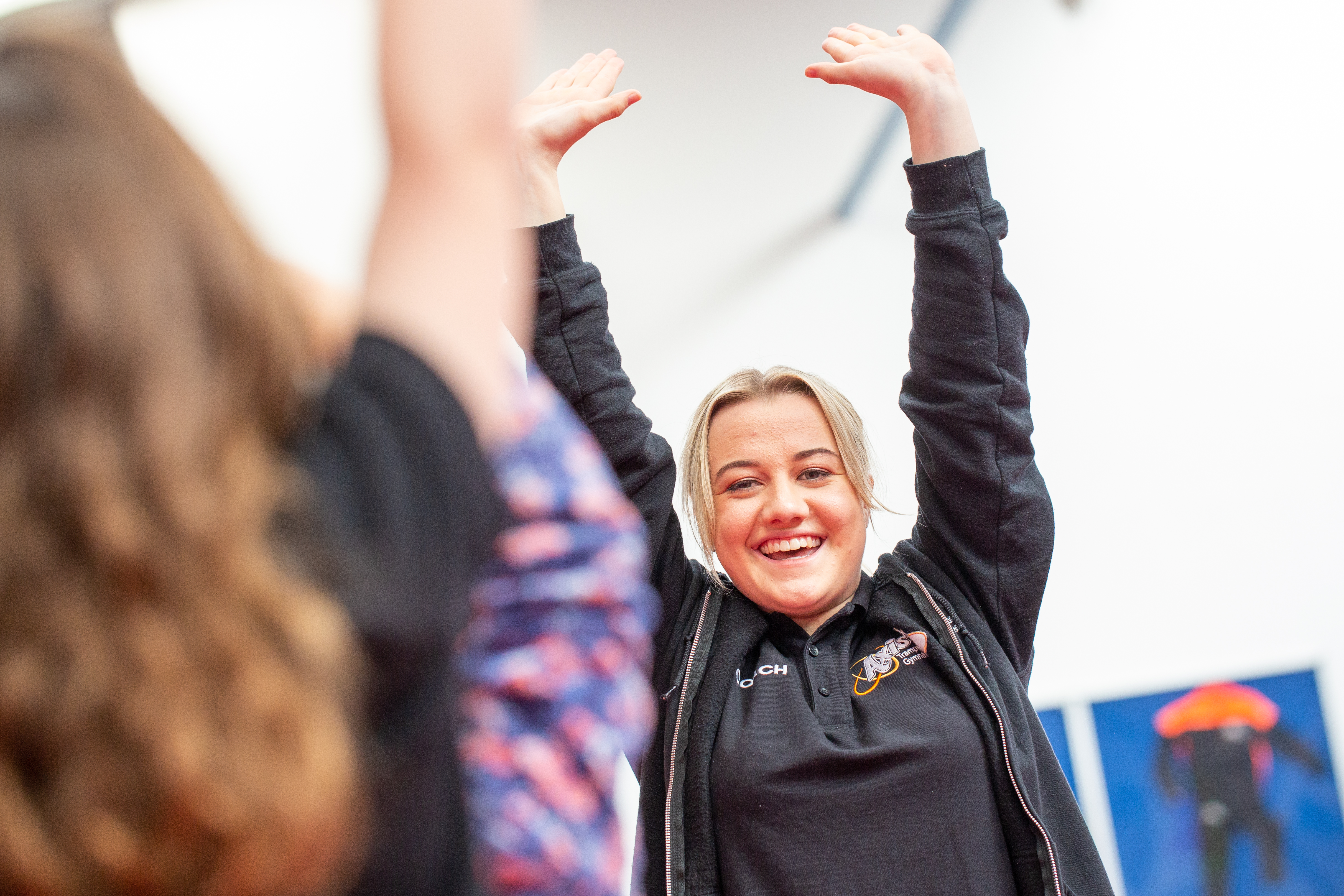 How to coach trampolining to kids - coach Hermione takes part in a warm-up game with the children
