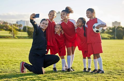 Coach taking a photo with participants