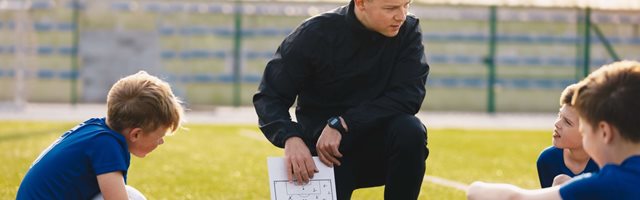 Coach talking strategy with young players