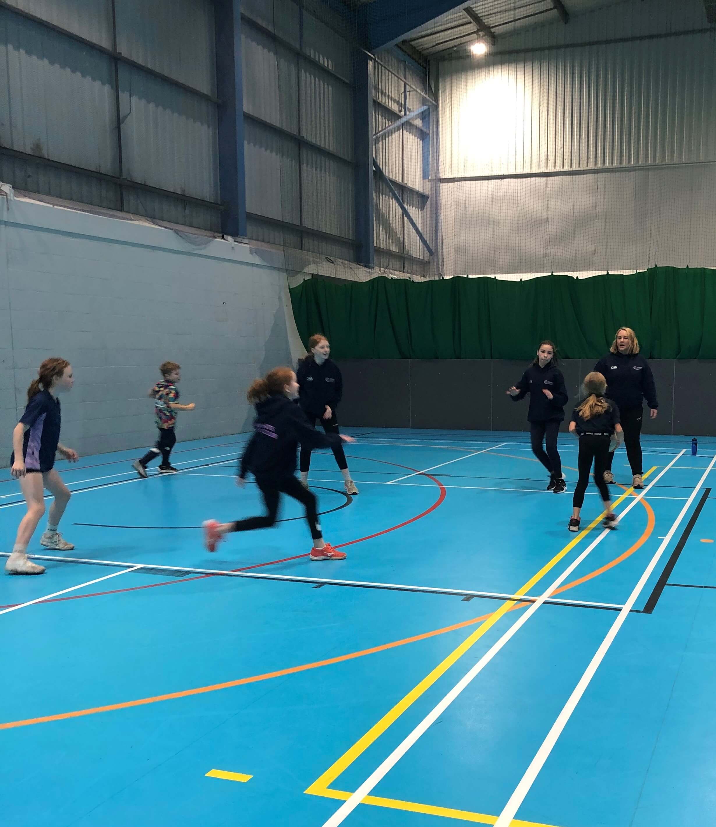 Coach Becky Evans delivering a session in a sports hall