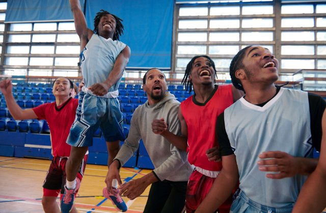 Teenage basketball team celebrating
