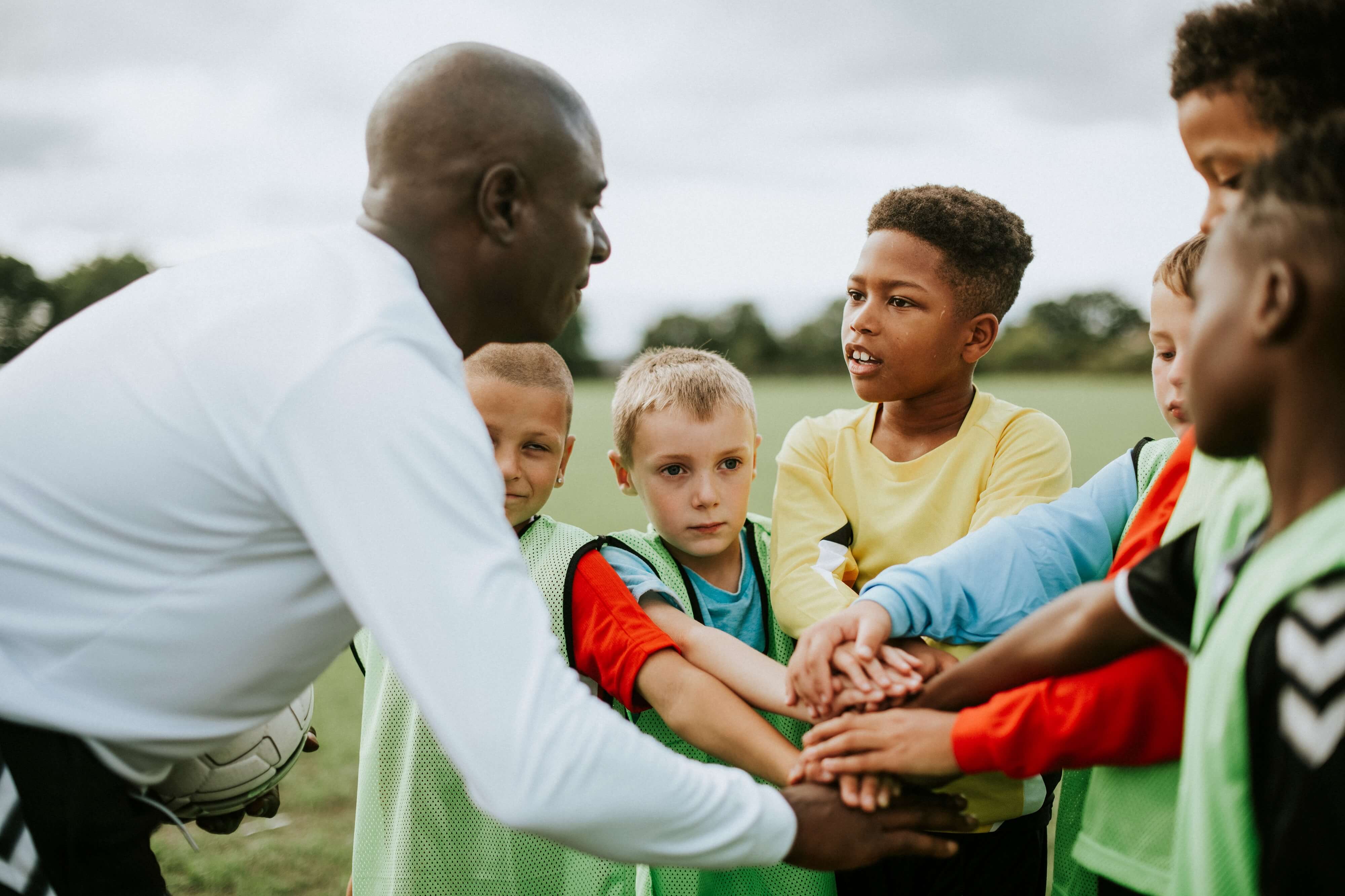 Coach doing huddle with kids